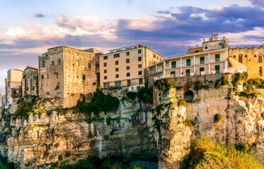 Fototapeta premium scenic travel landscape of beautiful historic town Tropea in Italy with old antique buildings, vintage houses on a high rock cliff above sea and amazing blue sky on background