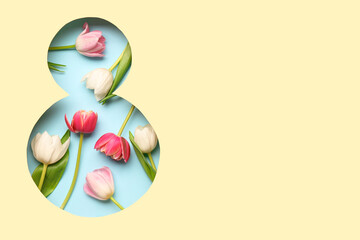 Cut beige paper in shape of figure 8 with beautiful tulip flowers on blue background. International Women's Day.