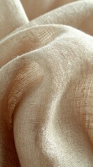 A detailed close-up of soft beige fabric, showcasing its intricate texture and weave, set against a clean, bright white background that enhances the fabric's warm tones.