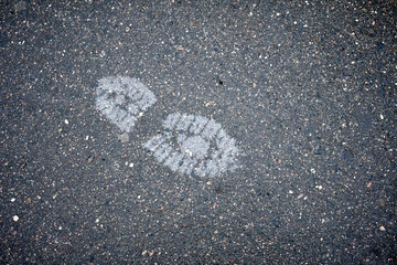Footprints on a pavement reflecting a journey on a cloudy day in the city