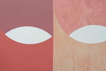 two almond-shapes composed of overlapping machine-cut paper sheets with curve elements