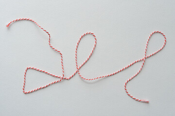 red and white twisted thread on blank paper