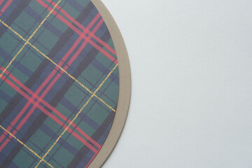 holiday plaid paper on millboard both with circular forms on blank paper
