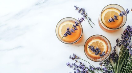 Drinks with lemon slices and lavender on white marble