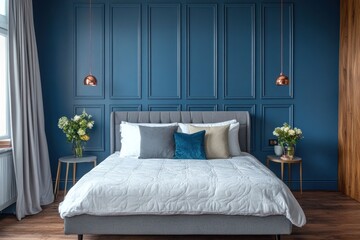 Elegant bedroom with blue wall paneling, gray bed, and white bedding.
