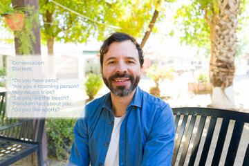 Man seen through augmented reality glasses, grinning while exploring digital communication interface in outdoor urban setting