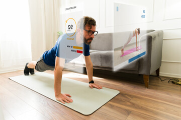 Man exercising at home using augmented reality glasses displaying workout data and a virtual...