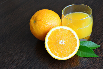 Fresh Orange Juice in drinking glass decorated with some orange fruits