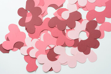 machine-cut stylized paper florals cut in half and scattered on a blank surface