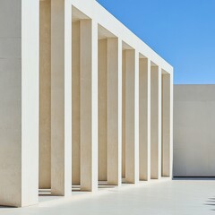 Fototapeta premium Modern Architectural Design Featuring Sleek White Columns in a Clear Blue Sky Setting During Daylight Hours