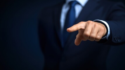 Fototapeta premium IT infrastructure concept. A businessman gestures assertively with a pointed finger against a dark backdrop.