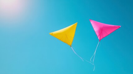 Two Triangular Kites Soaring in a Bright Blue Sky