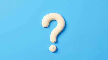 Naklejka premium Creamy Question Mark Shape on Blue Background for Conceptual Ideas