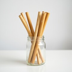 Bamboo straws in glass jar on white countertop