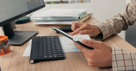 Close-up shot of a woman's hands holding a tablet, she clicks fingers on the screen, scrolls, checks email, news, social media updates, computer office, keyboard in the background