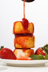  cheese fritters with strawberries syrup pouring breakfast dish