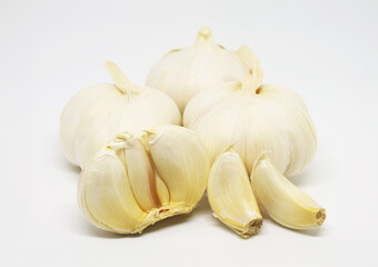 Closeup of Garlic Bulbs and Cloves Isolated on White Background