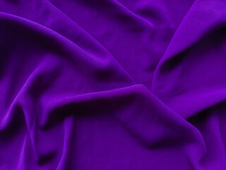 Wrinkled purple fabric texture background with wavy fabric surface. Soft and smooth purple fabric texture with a clean, minimalist, beautiful and elegant style. Crumpled silk or linen pattern.