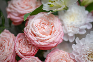 Delicate composition of white and pink roses in a basket