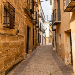 Obraz premium Picturesque narrow alleys with medieval-style stone buildings in the Unesco city of Ubeda, Jaen.