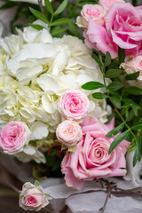 Delicate composition of white and pink roses in a basket