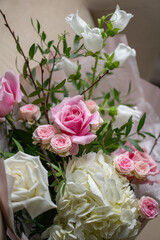 Delicate composition of white and pink roses in a basket