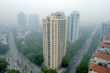 A gothic city engulfed in thick exhaust fumes, where streetlights barely shine through the smog