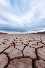 Fototapeta premium photograph captures barren cracked earth landscape stretching endlessly under cloudless sky showcasing harsh aftermath