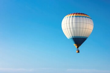 Fototapeta premium lone hot air balloon gracefully drifts across vast clear blue sky with ample copy space for text placement