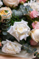 Delicate composition of white and pink roses in a basket