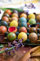 top view of a colored pallet with dyed Easter eggs with natural dyes