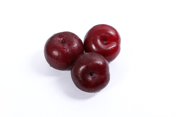 read plum fruits in white background  