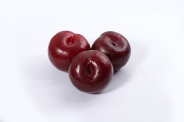 read plum fruits in white background  