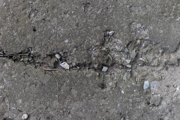 Background of destroyed concrete path, gray concrete, concrete texture, close-up. Natural photo. Old concrete slab