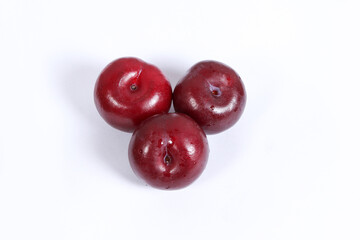 read plum fruits in white background  