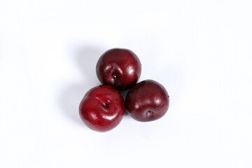 read plum fruits in white background  