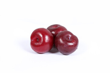 read plum fruits in white background  