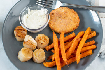 salmon burger with scallops and sweet potato fries,