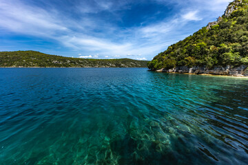 Obraz premium Wild rocky beach, Istrian Peninsula, crystal blue water, a place difficult to access for tourists Croatia