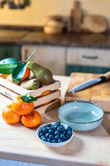 Fresh fruits and utensils on rustic kitchen countertop.