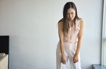 Tired, exhausted and lethargic middle aged asian woman yawning from lethargy, burnout insomnia, brain fog, vitamin or nutrition deficiency concept image