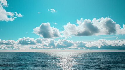 Obraz premium Stunning ocean seascape with bright blue sky and fluffy white clouds peaceful summer day sun calm