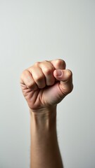 Accelerate action. Stay strong.  Hand is raised in the air with the fingers spread out. Concept of power and strength, as if the person is making a fist to show their determination or resolve