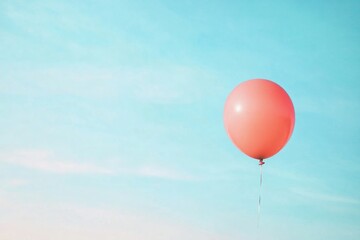 Fototapeta premium single vibrant red balloon suspended against expansive backdrop of serene blue sky illustrating unique abstract thinking