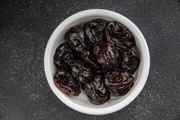 Dried prunes drained smoked plum delicious gourmet food background on the table rustic food top view copy space keto and paleo diet vegetarian and vegan food