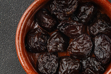 Dried prunes drained smoked plum delicious gourmet food background on the table rustic food top view copy space keto and paleo diet vegetarian and vegan food
