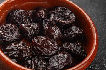 Dried prunes drained smoked plum delicious gourmet food background on the table rustic food top view copy space keto and paleo diet vegetarian and vegan food
