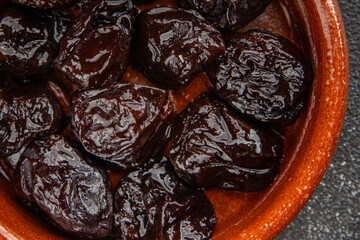 Dried prunes drained smoked plum delicious gourmet food background on the table rustic food top view copy space keto and paleo diet vegetarian and vegan food