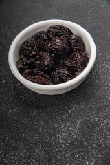 Dried prunes drained smoked plum delicious gourmet food background on the table rustic food top view copy space keto and paleo diet vegetarian and vegan food