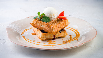 Belgian waffles with ice cream on a light background